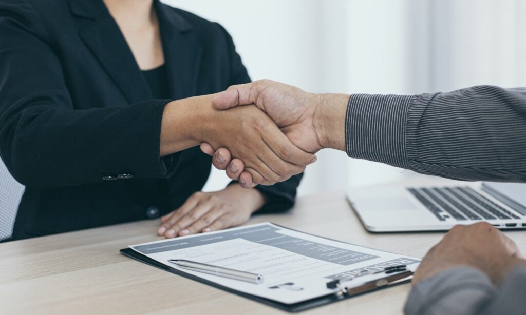 hand shaking between employer and interviewed. Hiring new employee as business grows